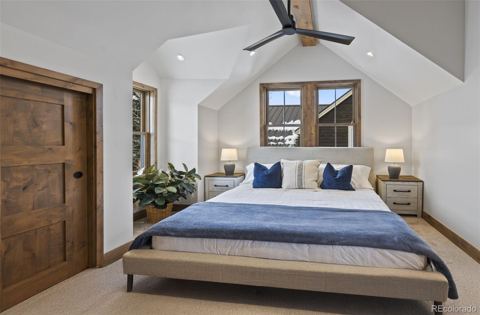 203 North Ridge Street, Unit B Breckenridge, CO 80424 - Photo 32 of 41 a bedroom with a balcony a bed and a chandelier