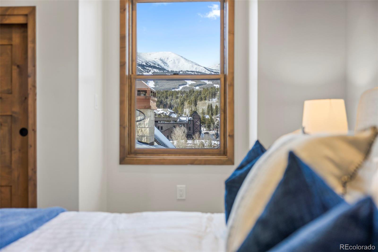 203 North Ridge Street, Unit B Breckenridge, CO 80424 - Photo 40 of 41 a bedroom with a bed and a painting on the wall