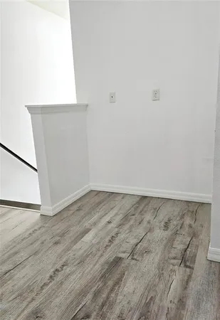 a view of an empty room and wooden floor