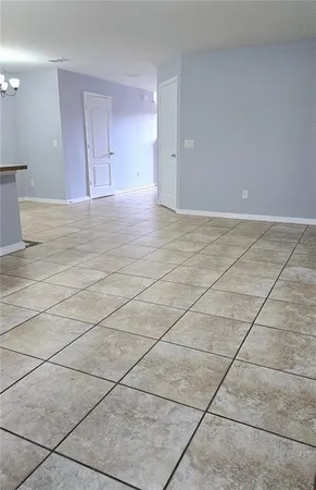 a view of an empty room and a window