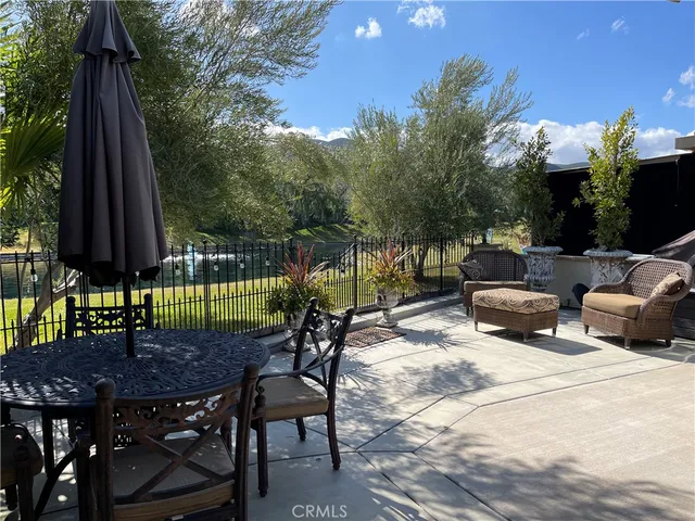 a view of a backyard with furniture and a garden