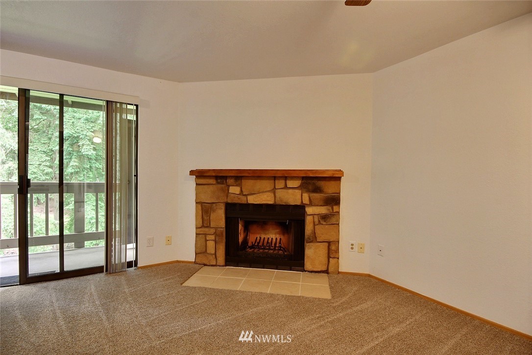 17419 119th Lane Southeast, Unit E31 Renton, WA 98058 - Photo 6 of 18 a room with fireplace and a fireplace