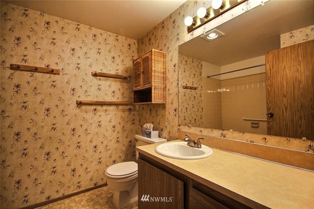 17419 119th Lane Southeast, Unit E31 Renton, WA 98058 - Photo 10 of 18 a bathroom with a granite countertop sink toilet and shower