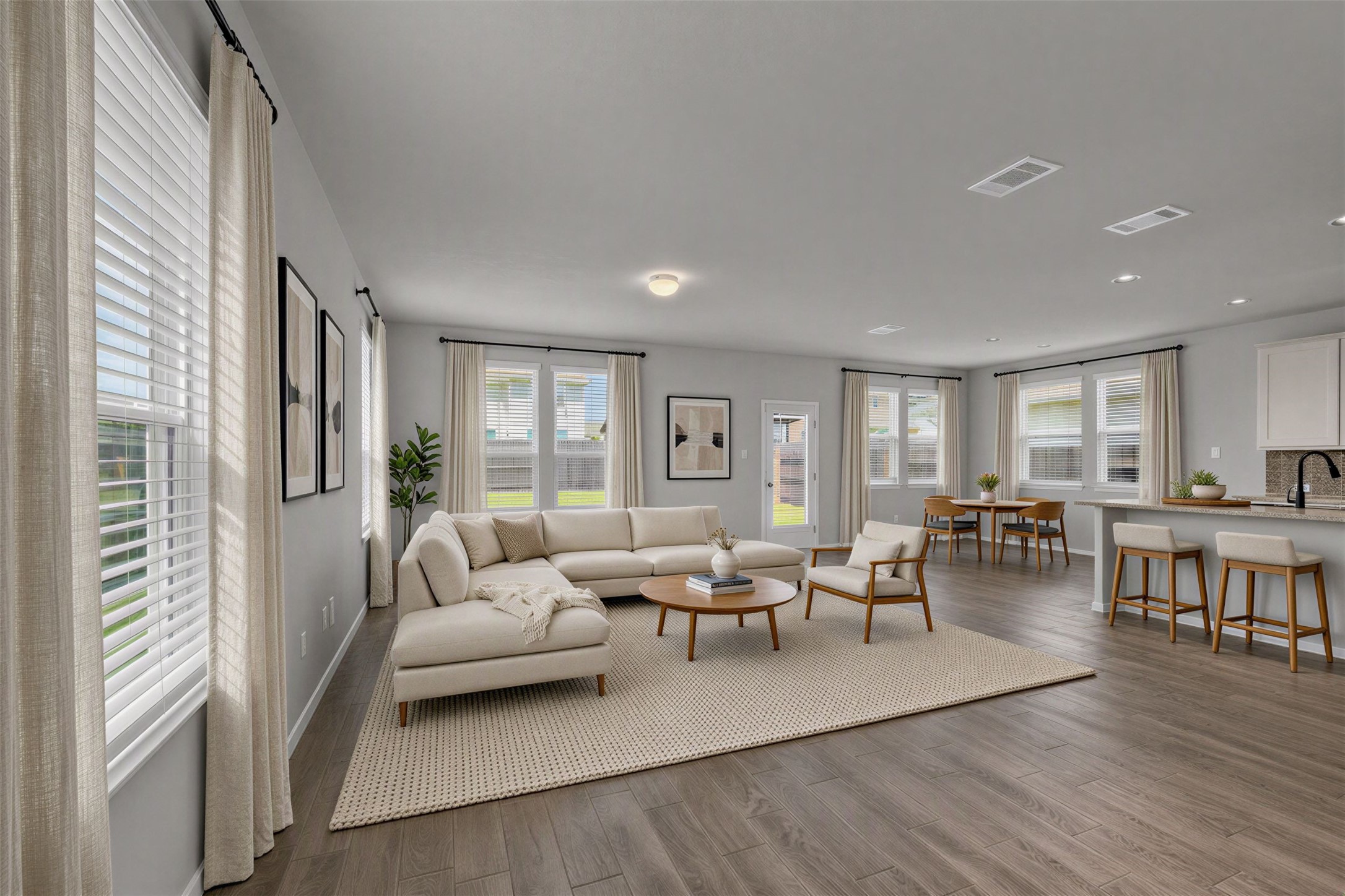101 Crescent Street Georgetown, TX 78626 - Photo 4 of 39 Virtually staged - Living area with a cohesive flow between lounge, dining, and kitchen zones.