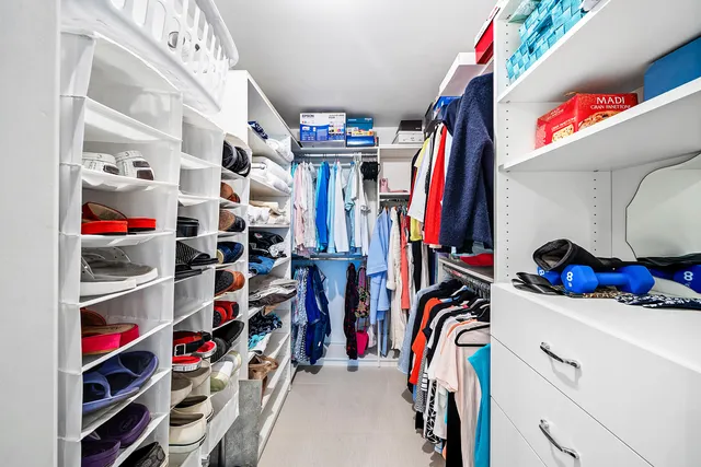 a living room with furniture and a large mirror