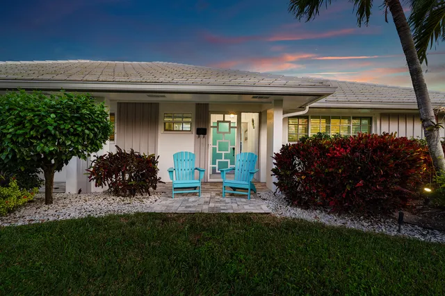 a view of a porch with furniture and a yard