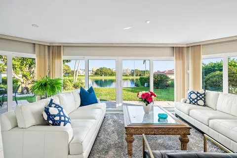 a living room with furniture and large windows