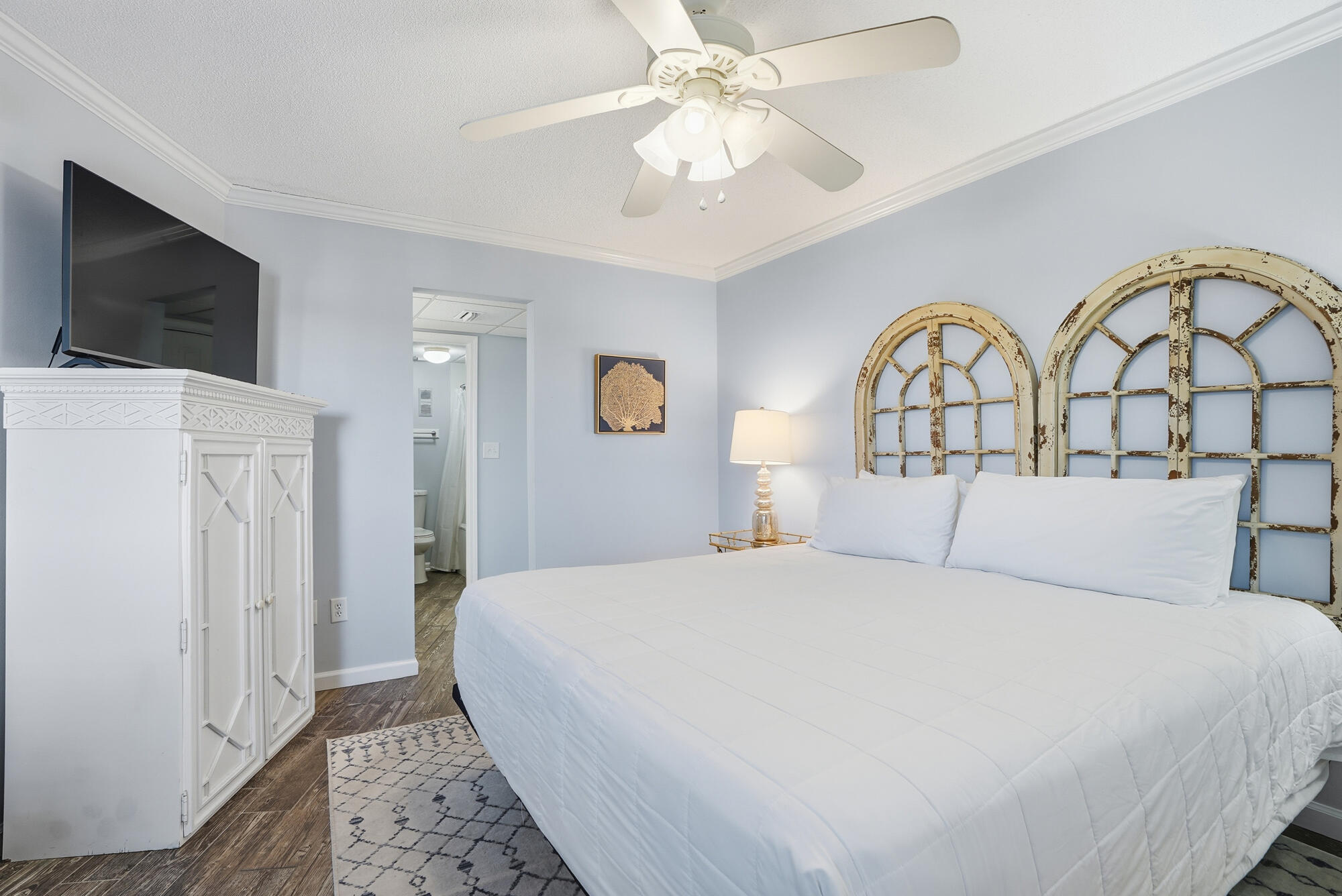 11483 Front Beach Road, Unit 105 Panama City Beach, FL 32407 - Photo 13 of 41 a bedroom with a large bed and a flat screen tv