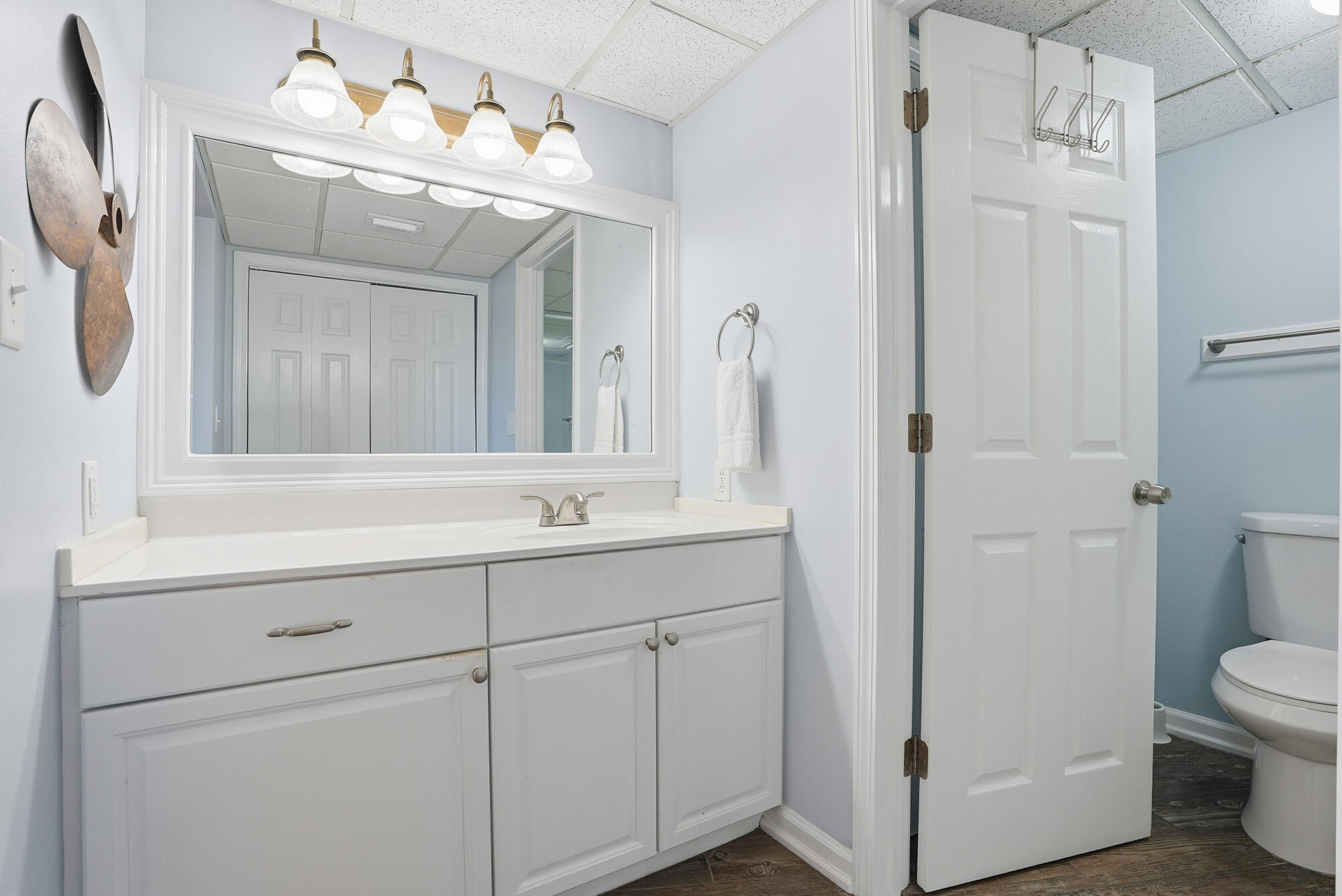 11483 Front Beach Road, Unit 105 Panama City Beach, FL 32407 - Photo 14 of 41 a bathroom with a double vanity sink mirror and toilet