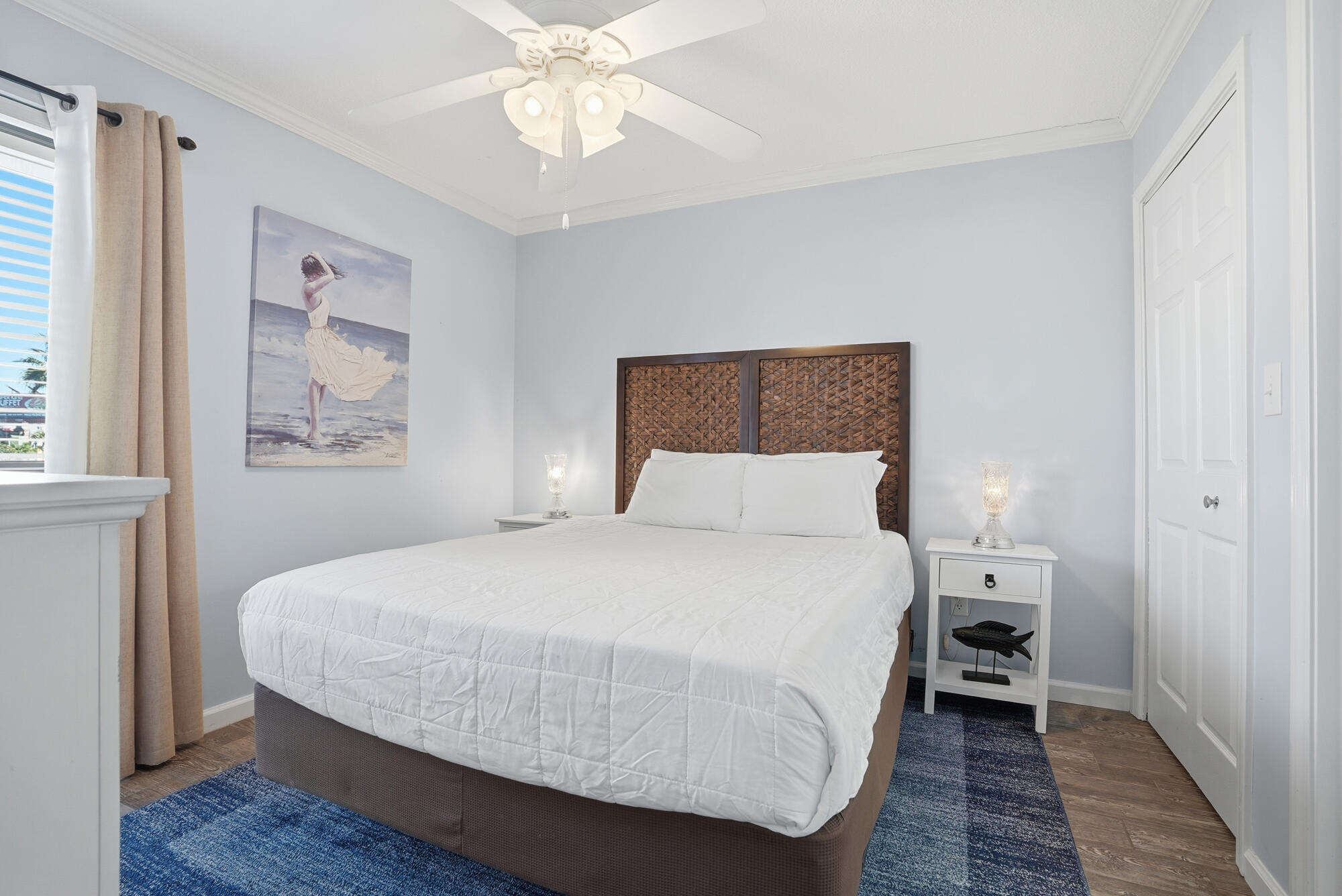 11483 Front Beach Road, Unit 105 Panama City Beach, FL 32407 - Photo 16 of 41 a bedroom with a bed and a chandelier