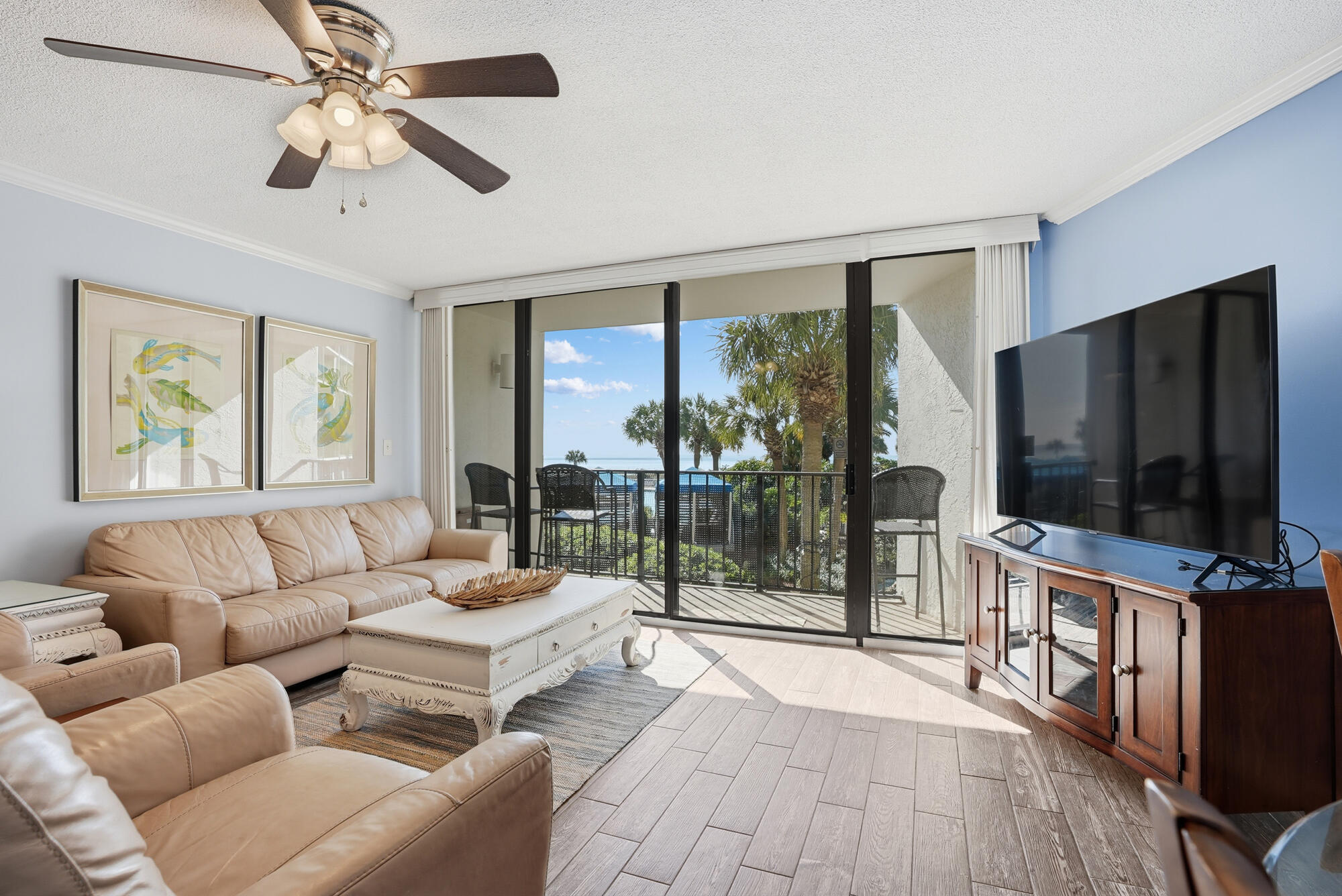 11483 Front Beach Road, Unit 105 Panama City Beach, FL 32407 - Photo 2 of 41 a living room with furniture a flat screen tv and a large window