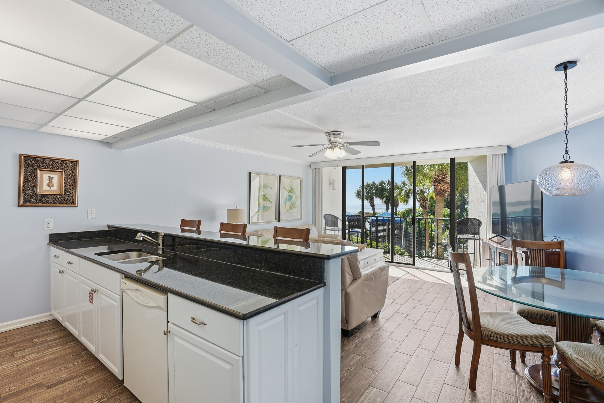 11483 Front Beach Road, Unit 105 Panama City Beach, FL 32407 - Photo 6 of 41 a kitchen with granite countertop a sink and cabinets