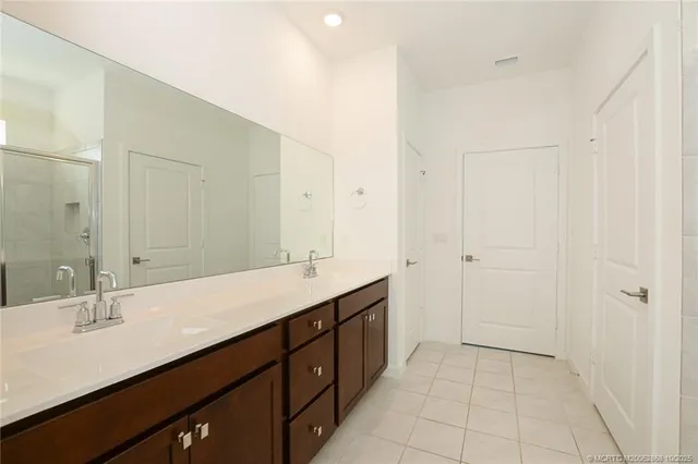 a bathroom with a double vanity sink and mirror