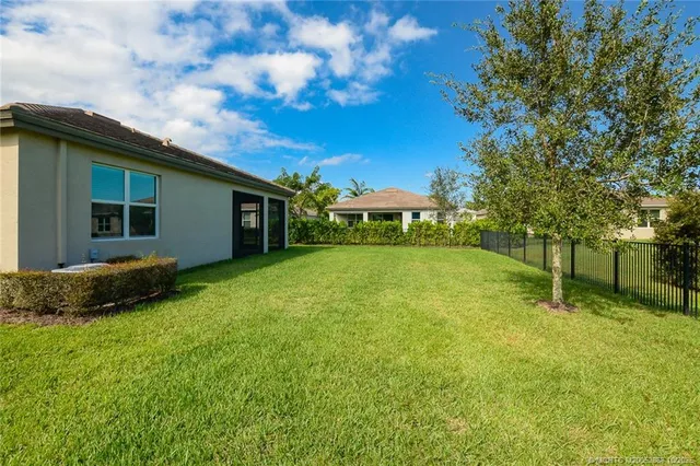 a backyard of a house with plants and garden