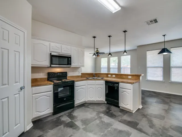 a kitchen with stainless steel appliances granite countertop a stove and a sink