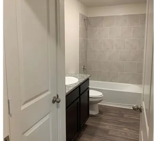 a bathroom with a toilet a sink and bathtub