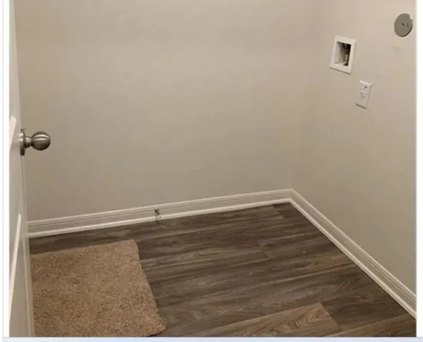 a view of a room with wooden floor