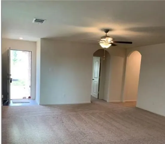 a view of a chandelier fan and entryway