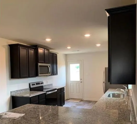 a bedroom with a bed tv and cabinets