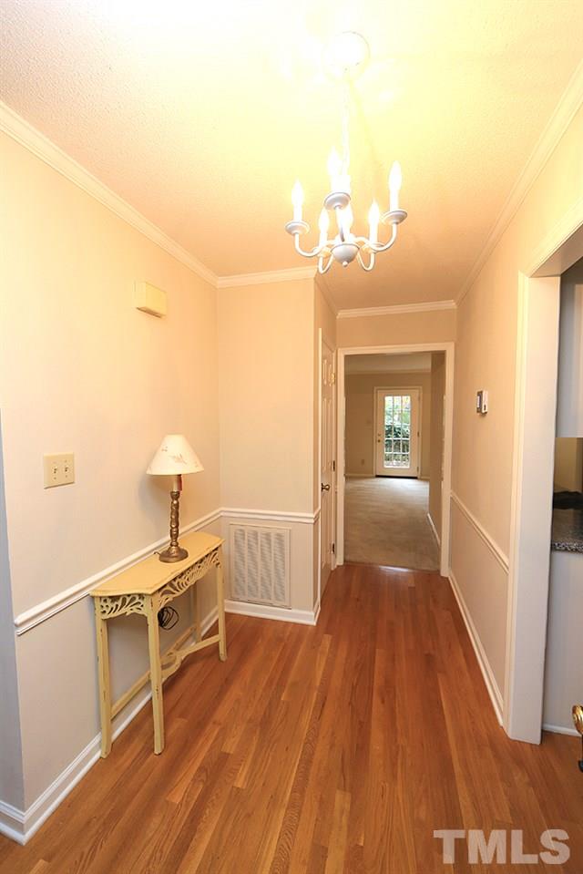 202 Bracken Court Raleigh, NC 27615 - Photo 3 of 19 Freshly painted foyer with gleaming hardwood floors greet you in this lovely home.