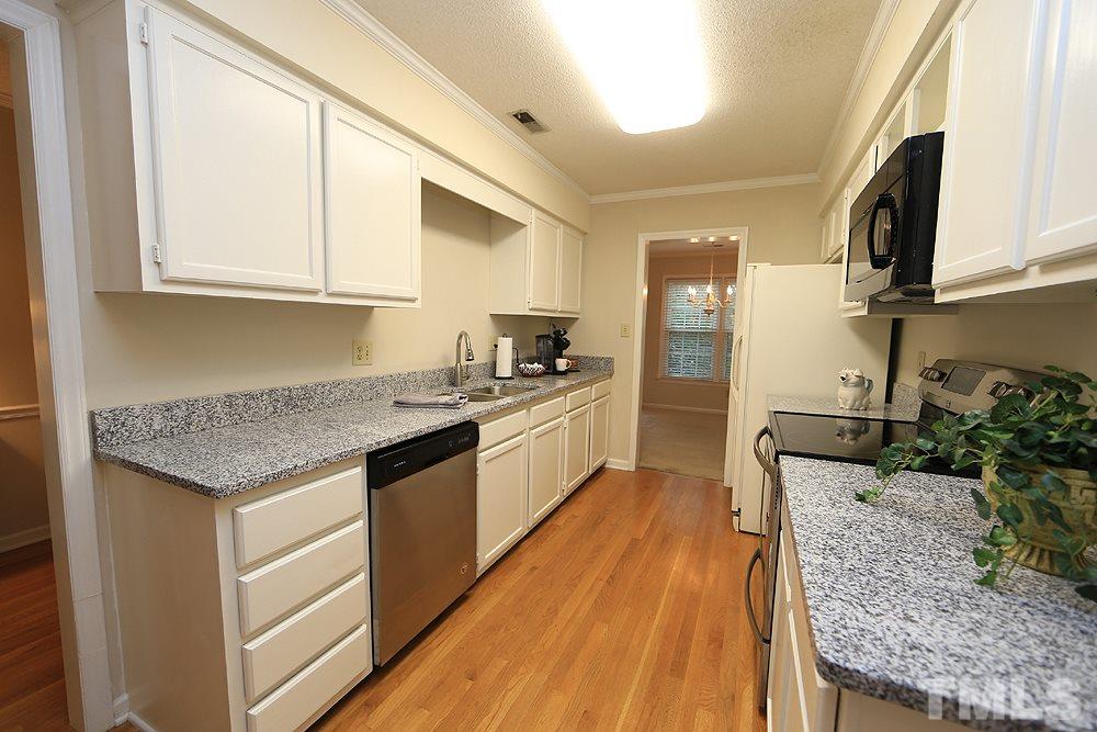 202 Bracken Court Raleigh, NC 27615 - Photo 4 of 19 Fully Updated Kitchen features brand new granite countertops, new dishwasher, sink, faucet & disposal. Freshly painted walls and cabinetry, too.