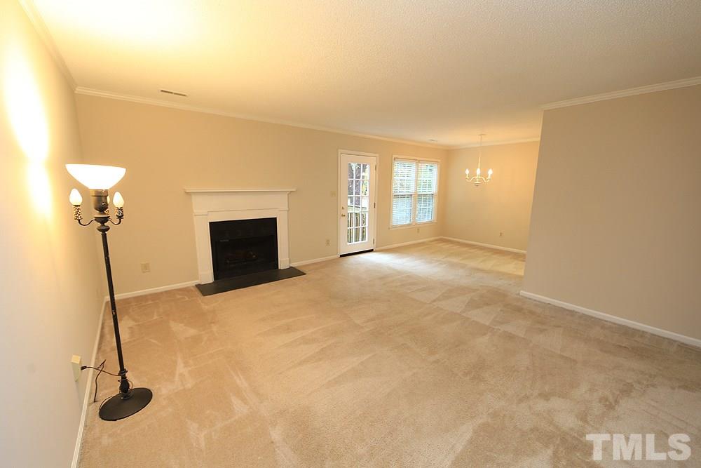 202 Bracken Court Raleigh, NC 27615 - Photo 9 of 19 Another view of the living space which boasts a separate dining room. This townhome has all new windows, too!