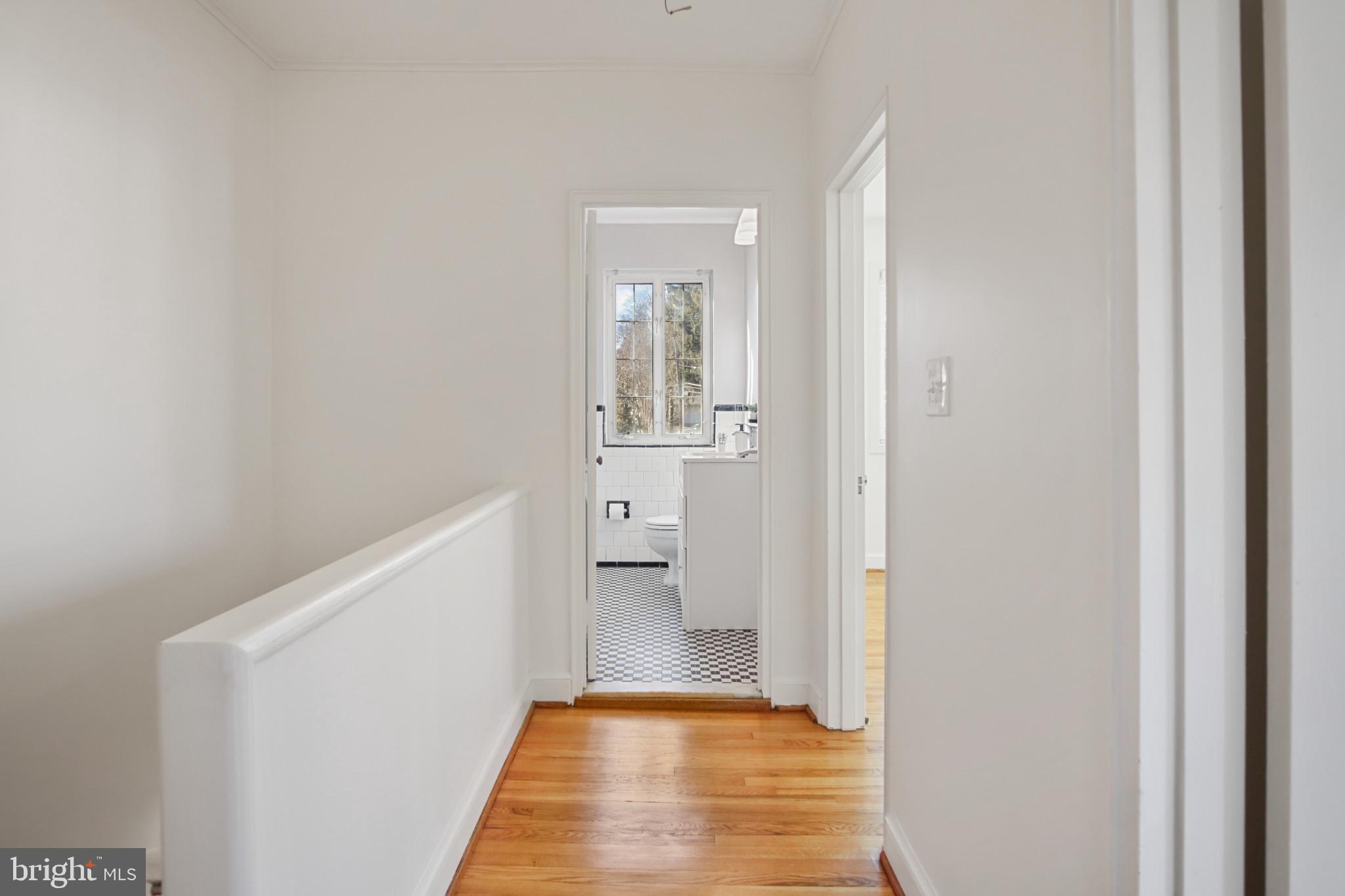 69 Aigburth Avenue Towson, MD 21286 - Photo 13 of 33 a view of a hallway with wooden floor and a bathroom