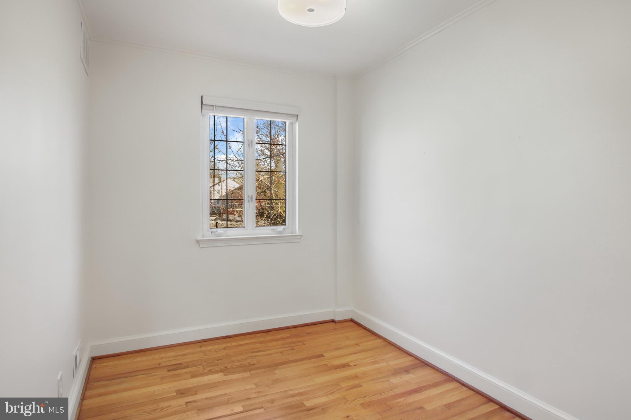 69 Aigburth Avenue Towson, MD 21286 - Photo 21 of 33 a view of an empty room with wooden floor and a window