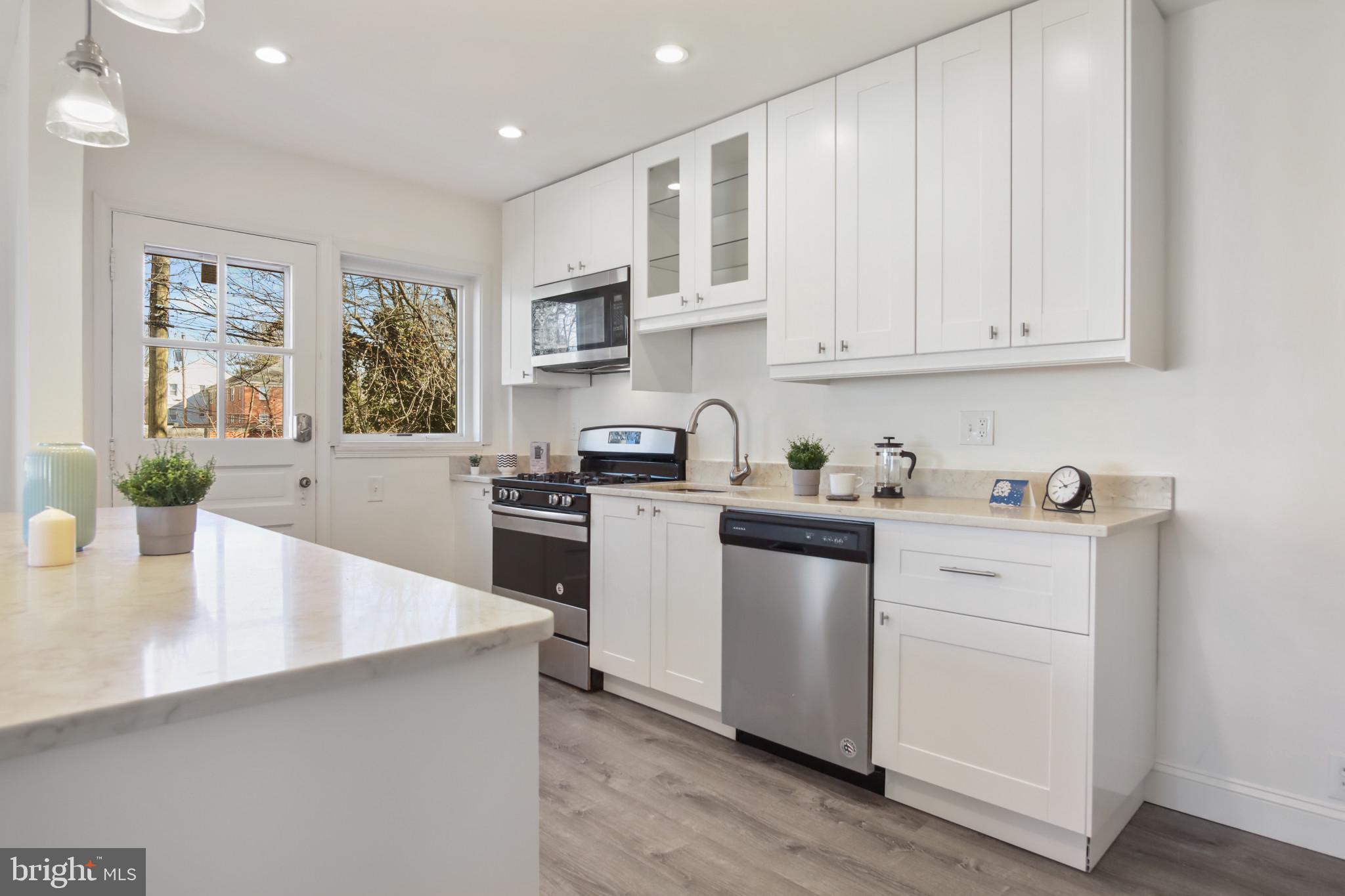 69 Aigburth Avenue Towson, MD 21286 - Photo 6 of 33 a kitchen with granite countertop white cabinets and white appliances