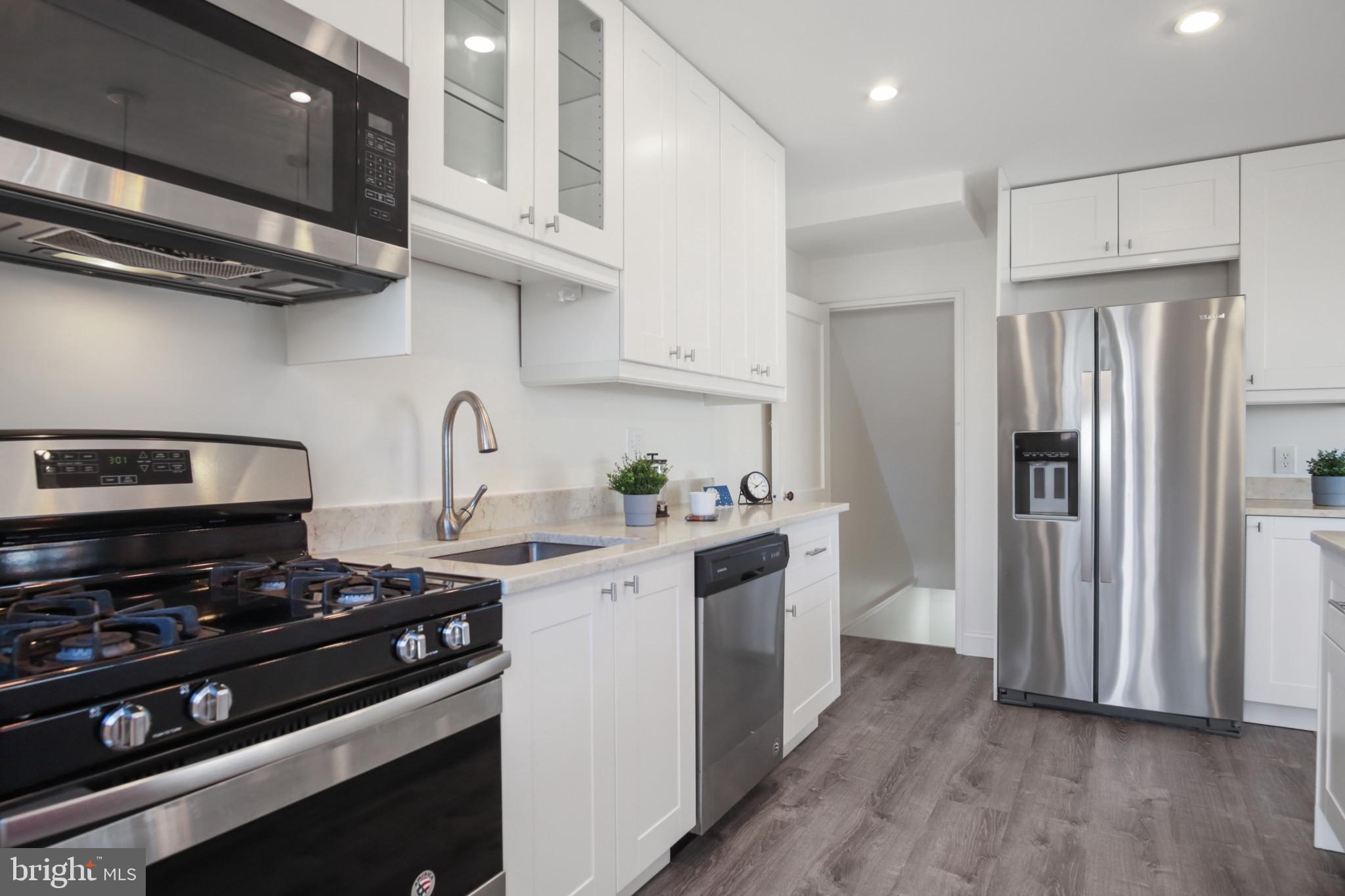 69 Aigburth Avenue Towson, MD 21286 - Photo 8 of 33 a kitchen with stainless steel appliances a sink a stove and a refrigerator