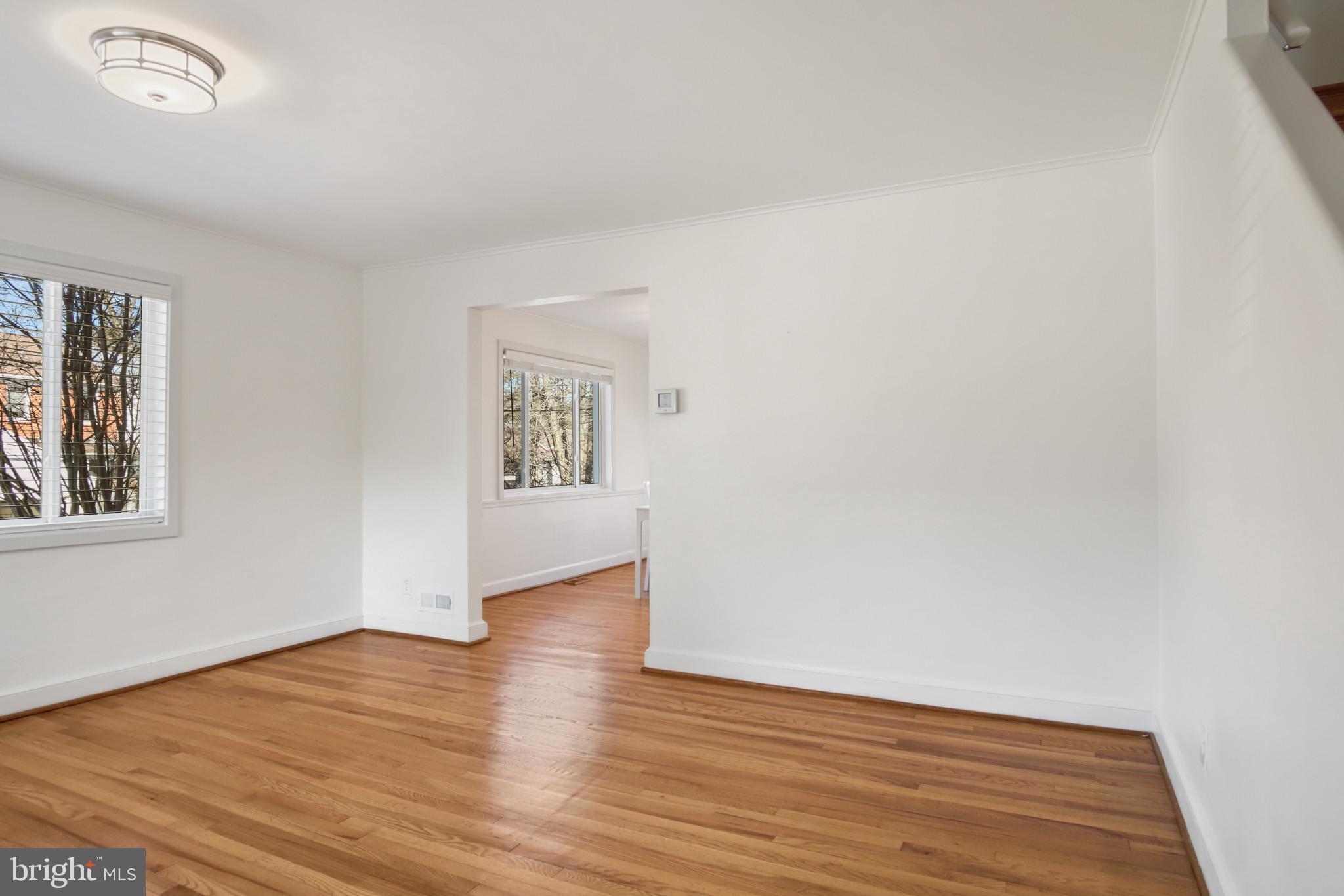 69 Aigburth Avenue Towson, MD 21286 - Photo 10 of 33 a view of an empty room with wooden floor and a window