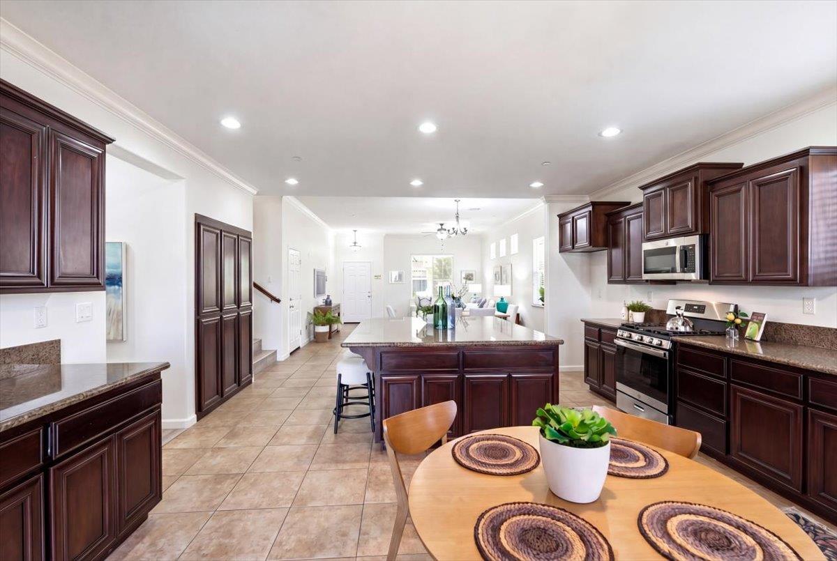 2036 Vignolia Loop Roseville, CA 95747 - Photo 13 of 27 a kitchen with a table and chairs in it