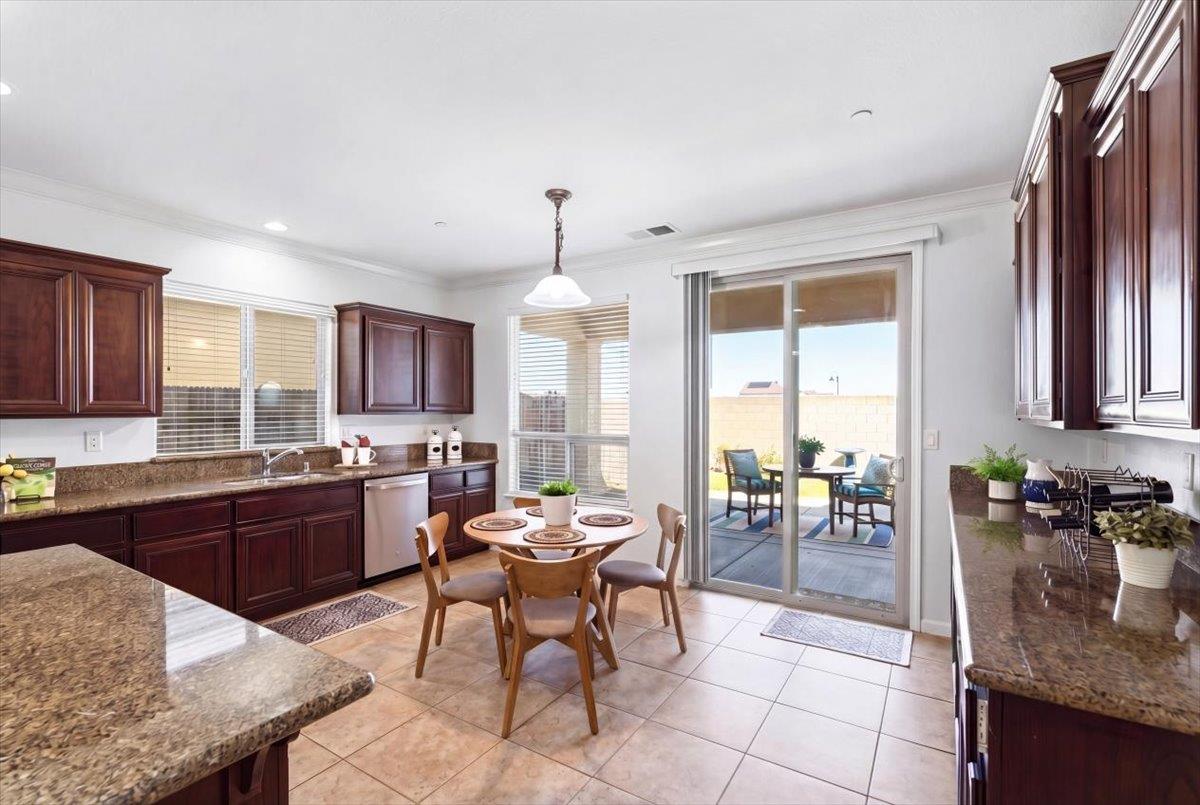 2036 Vignolia Loop Roseville, CA 95747 - Photo 14 of 27 a kitchen with granite countertop lots of counter top space dining table and stainless steel appliances