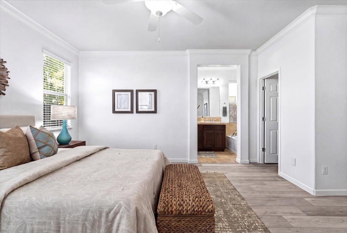 2036 Vignolia Loop Roseville, CA 95747 - Photo 17 of 27 a bedroom with a bed and a chandelier