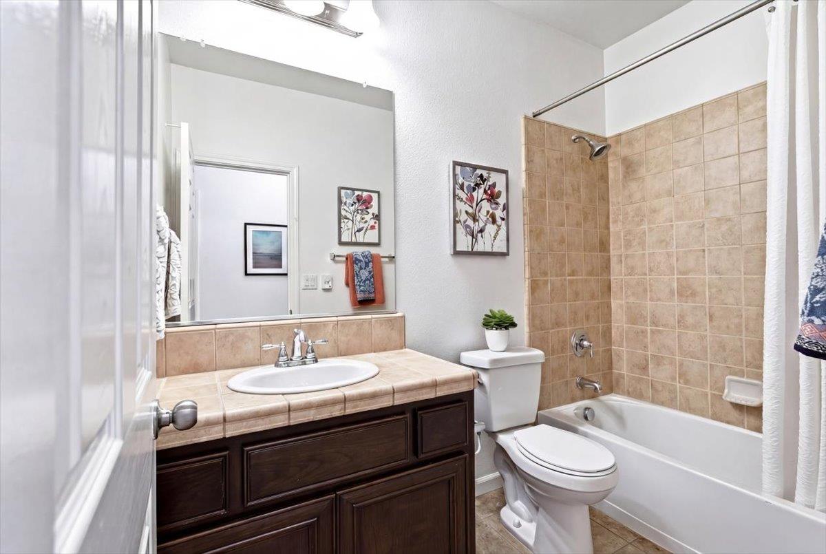 2036 Vignolia Loop Roseville, CA 95747 - Photo 22 of 27 a bathroom with a sink toilet a mirror and shower