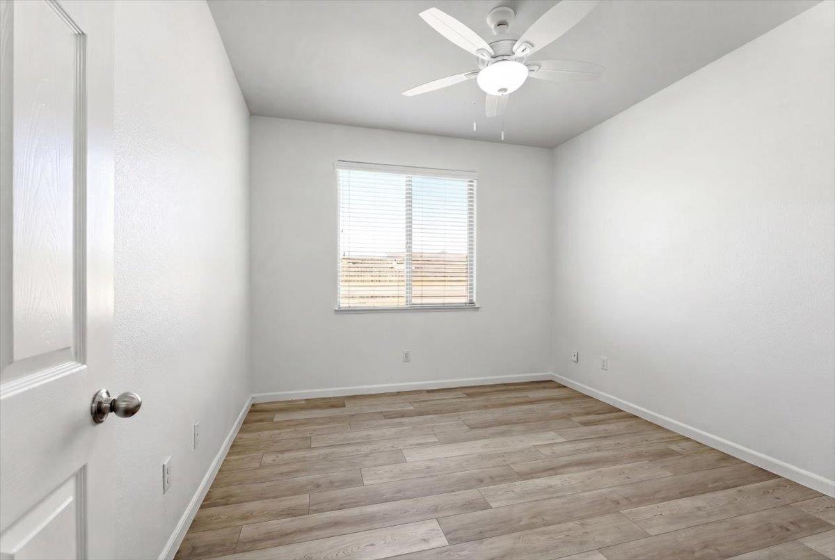2036 Vignolia Loop Roseville, CA 95747 - Photo 24 of 27 wooden floor in an empty room with a window