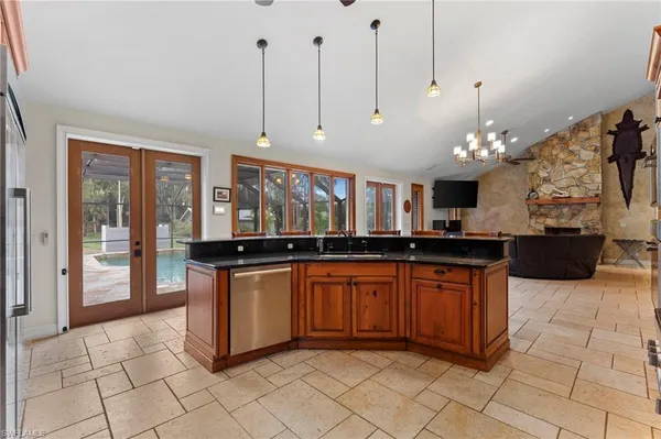 a kitchen with stainless steel appliances granite countertop a stove and a sink