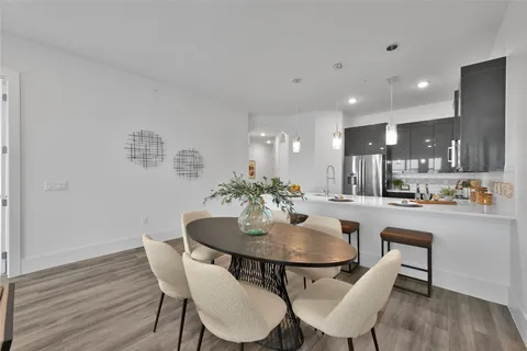 a dining room with furniture and wooden floor
