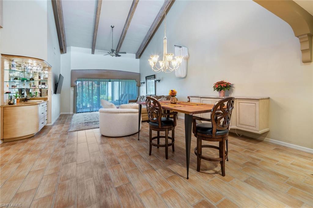 a view of a dining room with furniture and chandelier
