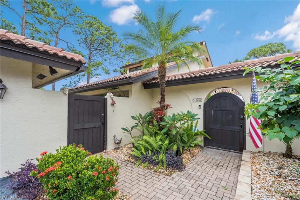 646 Augusta Boulevard Naples, FL 34113 - Photo 19 of 23 a front view of a house with a yard and garage