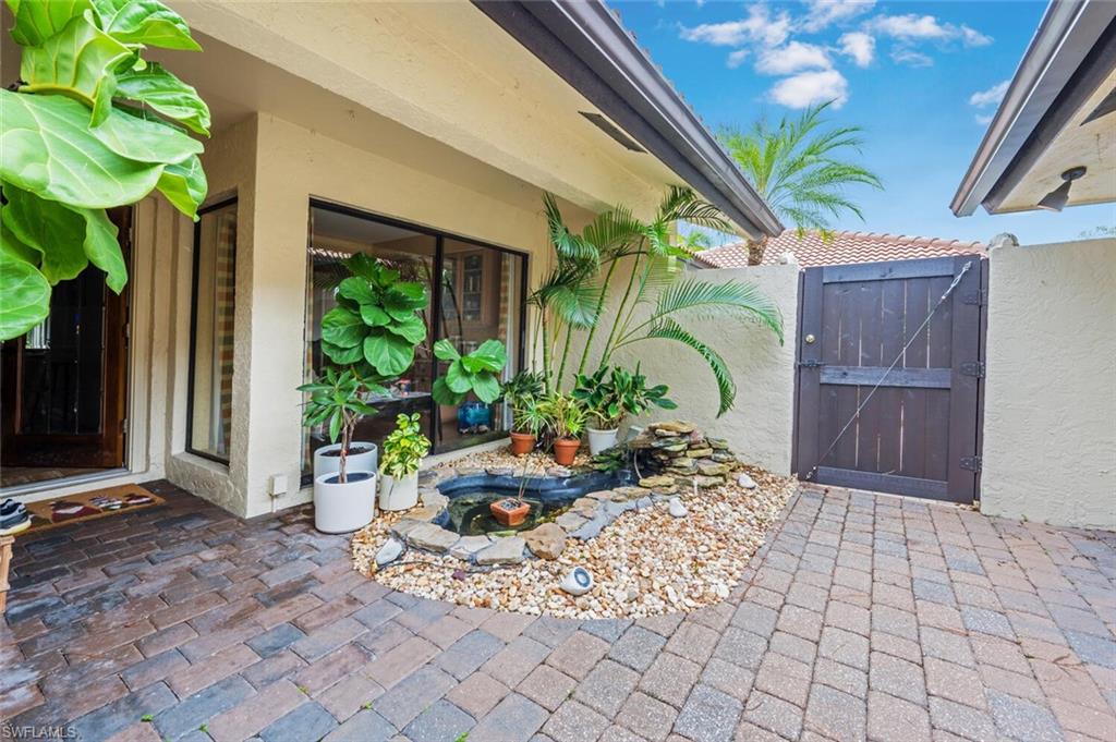 646 Augusta Boulevard Naples, FL 34113 - Photo 20 of 23 a potted plant sitting in front of a house