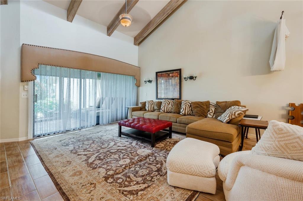 646 Augusta Boulevard Naples, FL 34113 - Photo 2 of 23 a living room with a couch and a large window