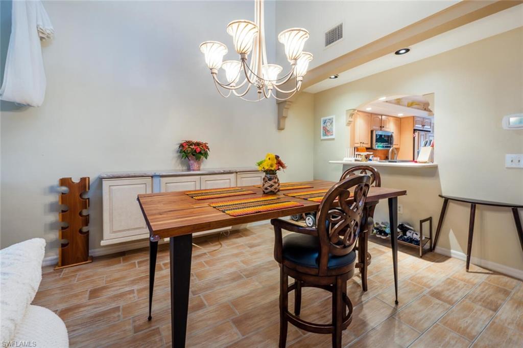 646 Augusta Boulevard Naples, FL 34113 - Photo 3 of 23 a view of a dining room with furniture and a chandelier