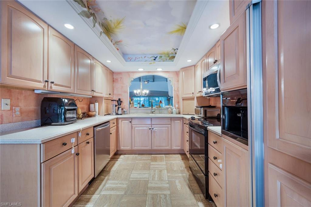 646 Augusta Boulevard Naples, FL 34113 - Photo 4 of 23 a kitchen with stainless steel appliances granite countertop a refrigerator and a stove top oven