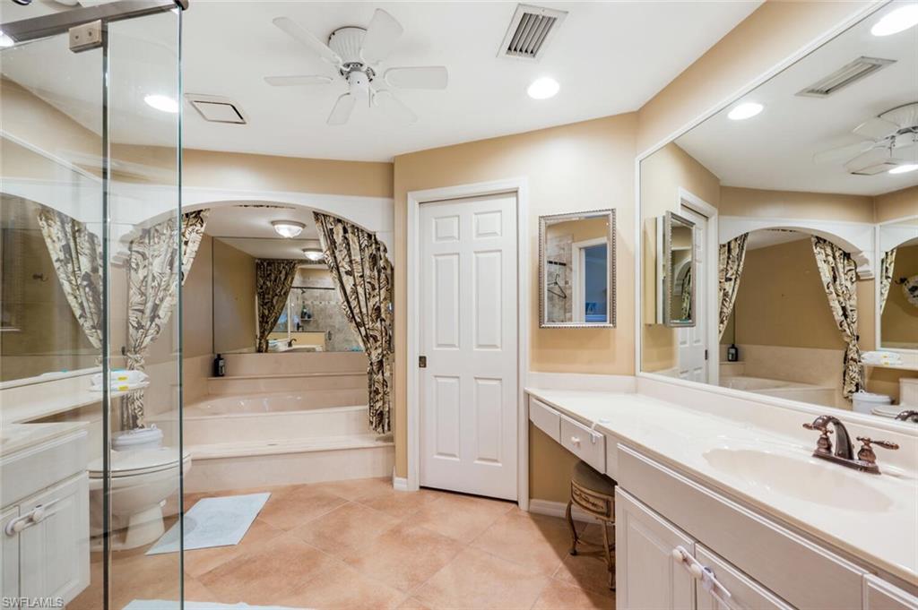 646 Augusta Boulevard Naples, FL 34113 - Photo 9 of 23 a spacious bathroom with a sink a vanity a mirror and shower