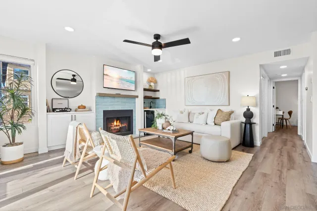 a living room with furniture a flat screen tv and a fireplace