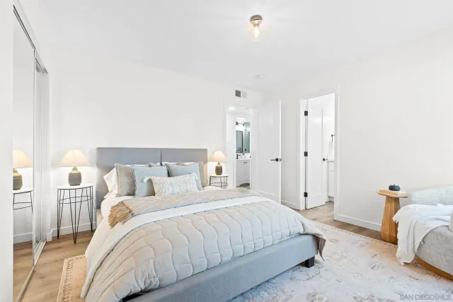 a spacious bedroom with a bed and a couch