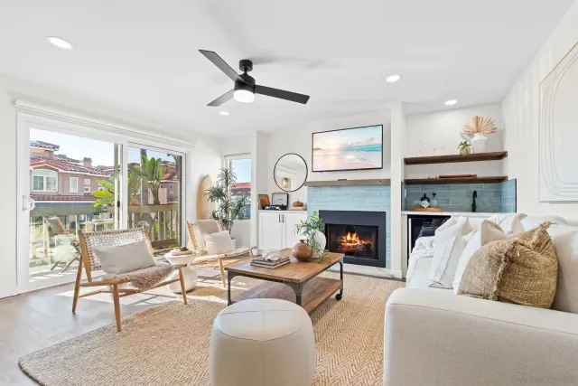 a living room with furniture fireplace and a large window