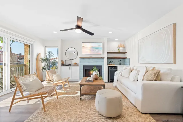 a living room with furniture kitchen view and a fireplace