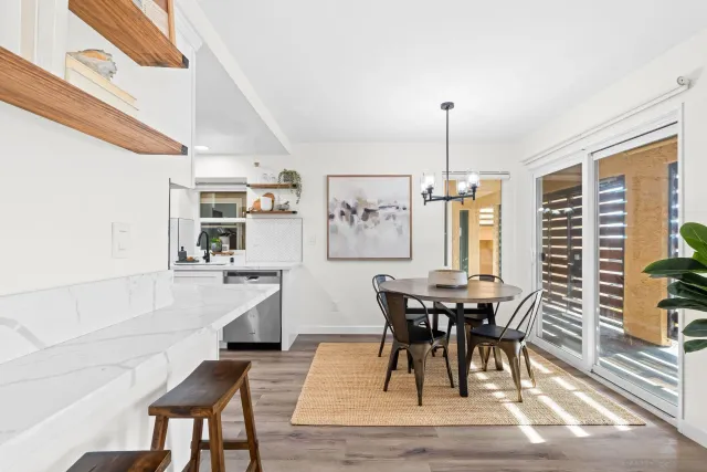 a dining room with furniture window and wooden floor